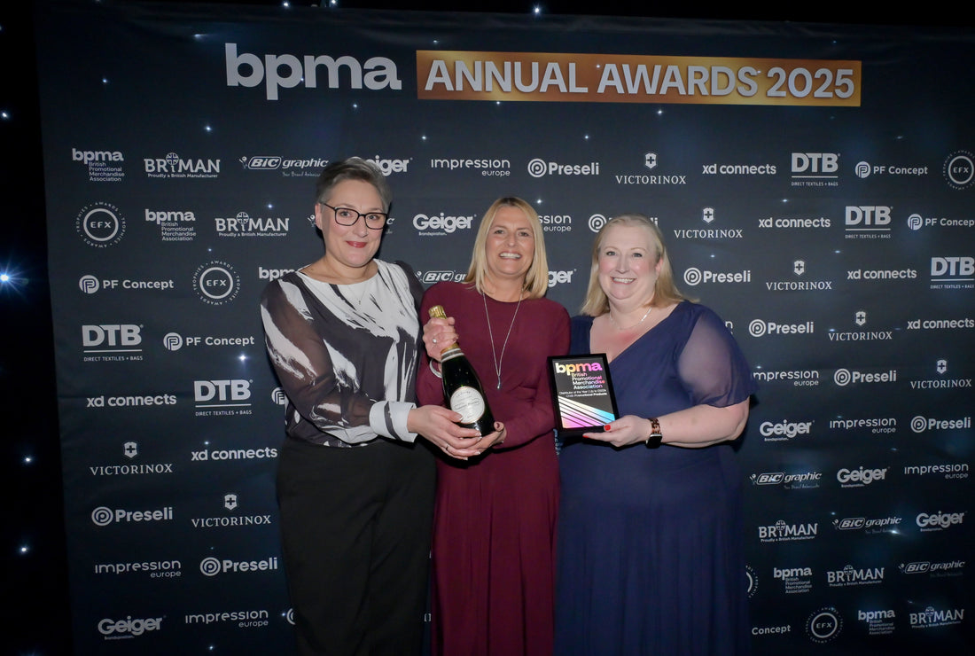 Photo of Jody & Lisa being present with award and Champagne.